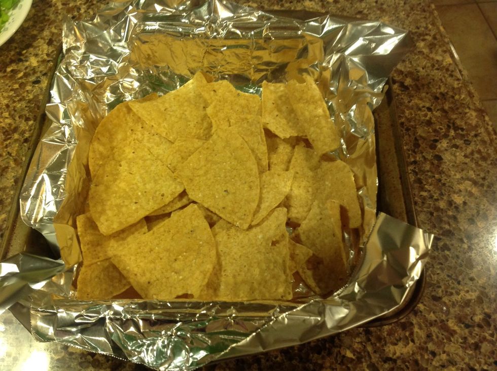 Line a pan with aluminum foil so you won't even have to wash that pan later. Win! Arrange chips in a single layer.