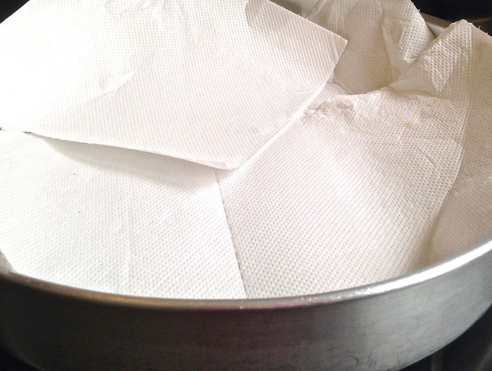 Line a plate with kitchen paper.