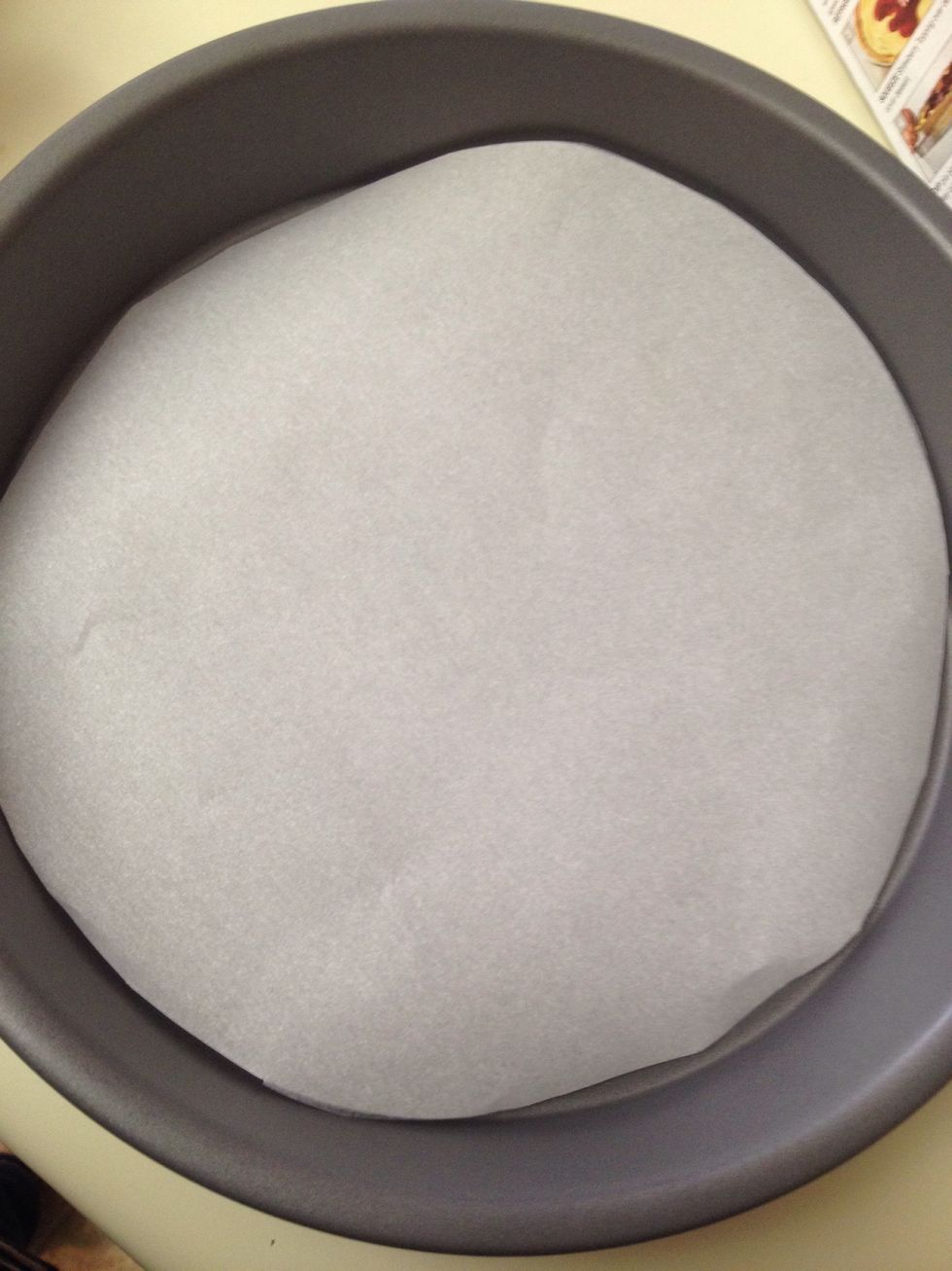Line a round cake pan with parchment paper.