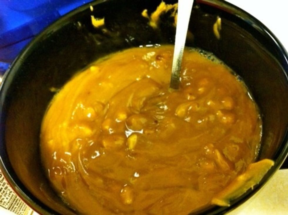 Line an 8x8 pan with foil and spray with cooking spray. In a medium bowl, melt peanut butter and butter together in microwave (about 1 minute).