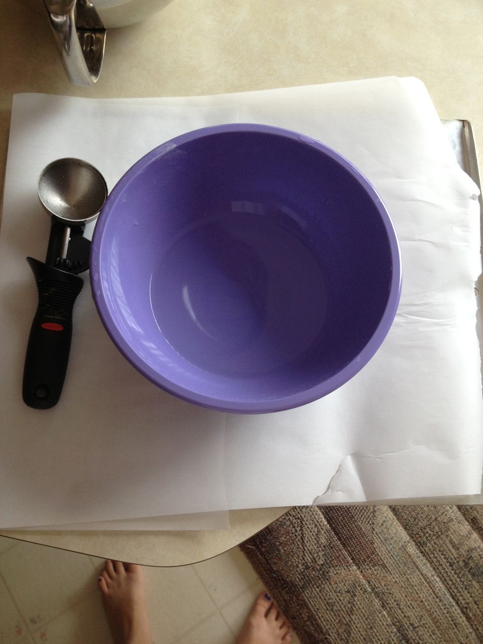 Line baking sheet with parchment paper, get a bowl of warm water, and get a 1/4 cup measure (I use an ice cream scoop)