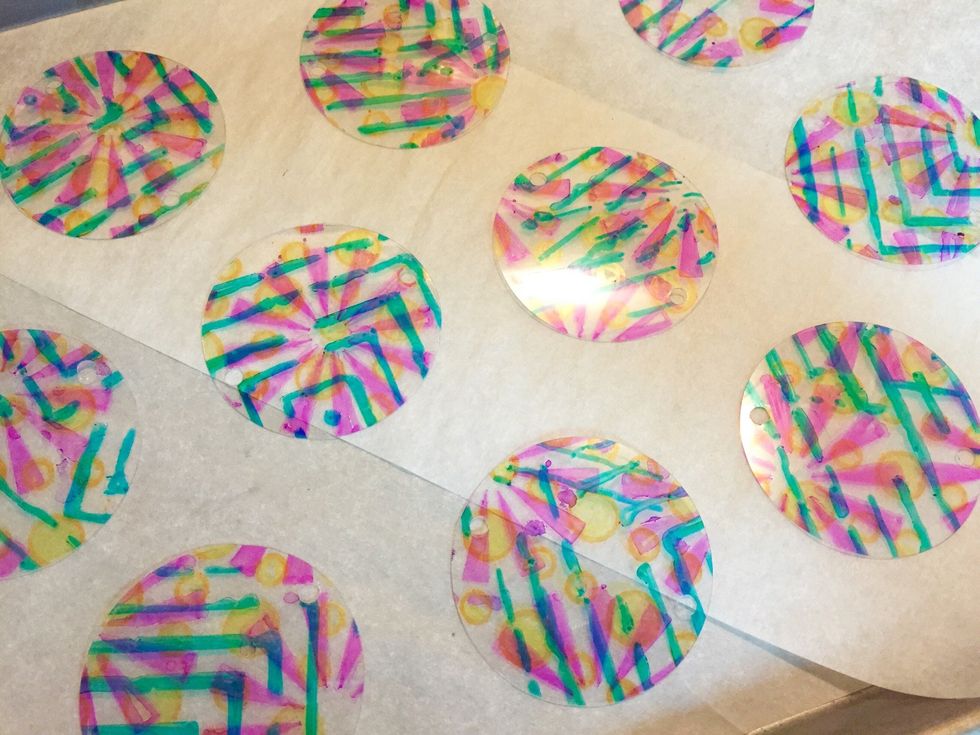 line baking sheet with parchment paper. lay circles on sheet - making sure all same sides are up - and bake Shrink Film pieces according to package directions.