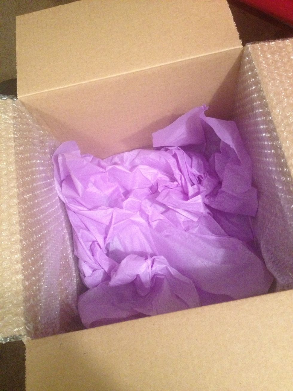 Line box with bubble wrap, tissue paper or shipping popcorn. It's really a personal preference. This is the way I choose to pack the box.