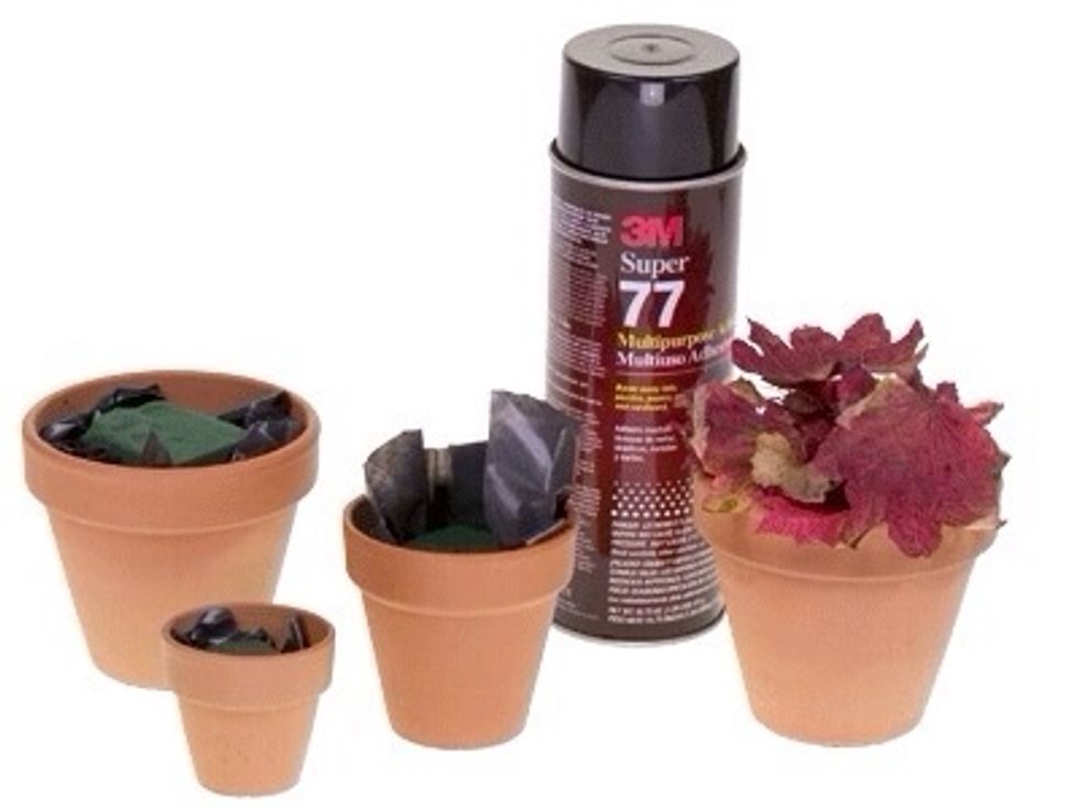 Line each pot with a square cut from the garbage bag. Insert a small piece of pre-soaked floral foam into the pot. Notice both the foam and the bag are below the lip of the pot so they will not show.