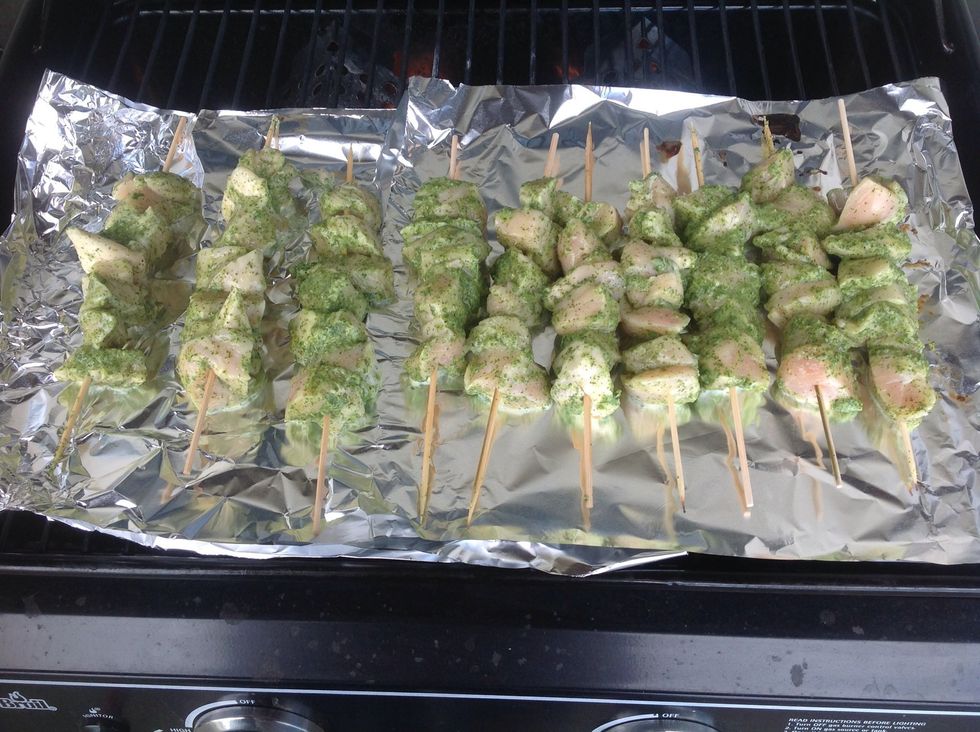 Line grill with tin foil then put chicken skewers on the grill.