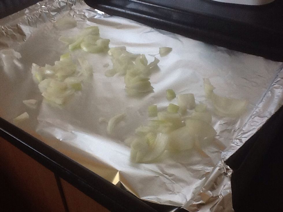 Line oven tray with aluminium foil and spread the chopped onions on it.