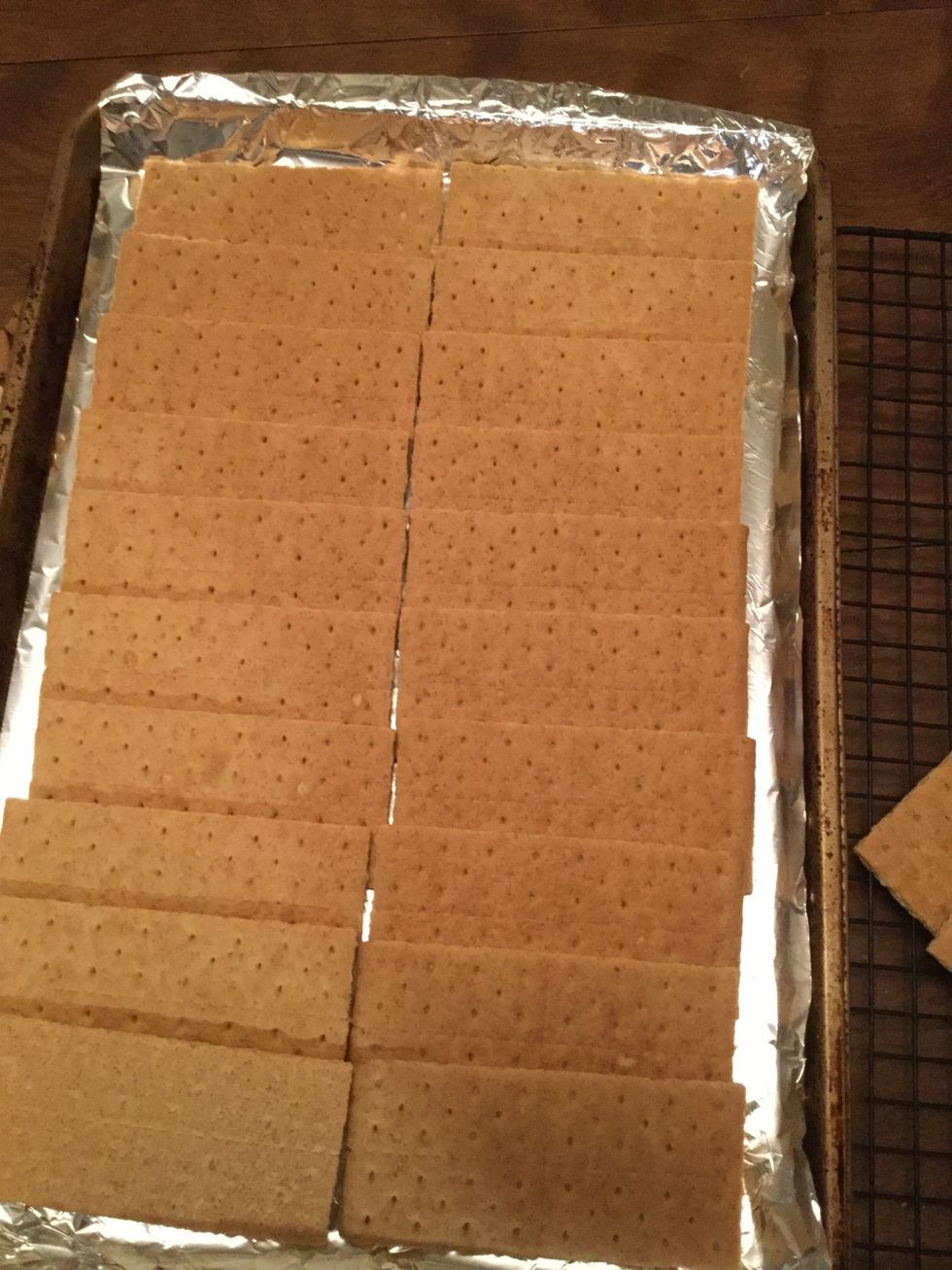 Line the 24 graham crackers on the foiled cookie sheet, they should over lap about 1/4 of the cracker long ways (follow the perforated lines long ways