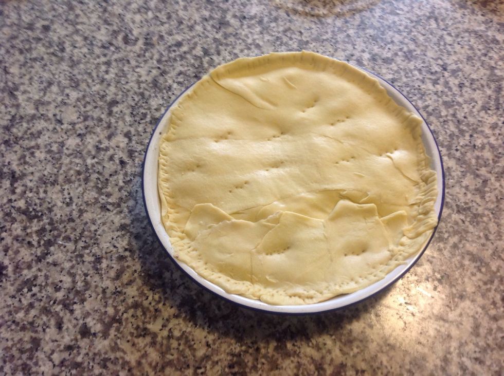 Line the baking tin with the pastry, add the mixture and close by more pastry. Brushing the pie with milk will give it a nice sheen during baking.