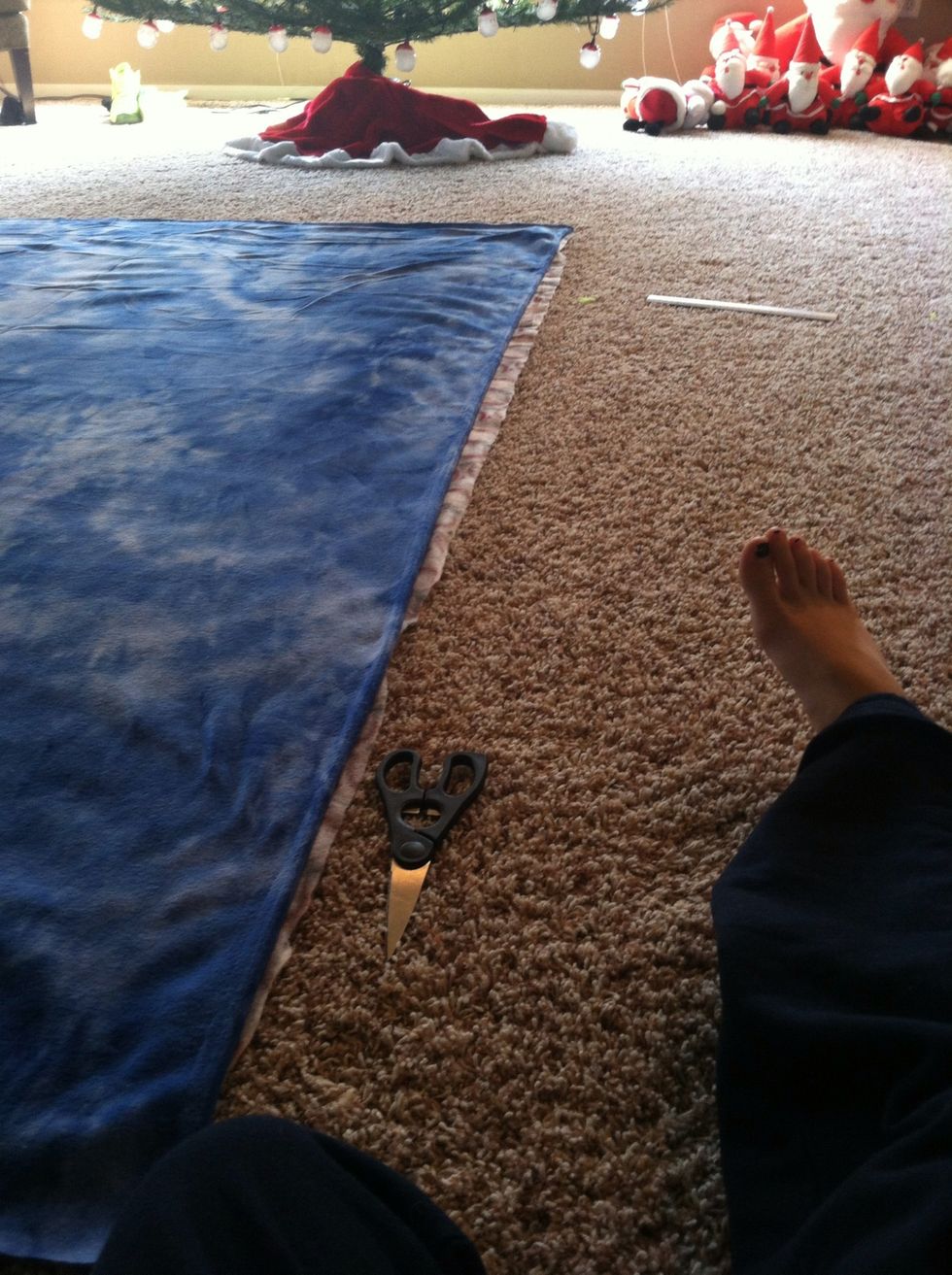 Line the blankets up on top of each other. It doesn't have to be perfect because you will be cutting it. And fabric scissors work really good