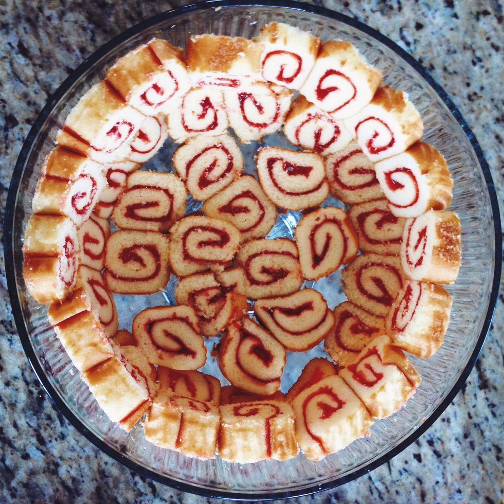 Line the bottom and sides of a trifle dish with slices of jelly roll.