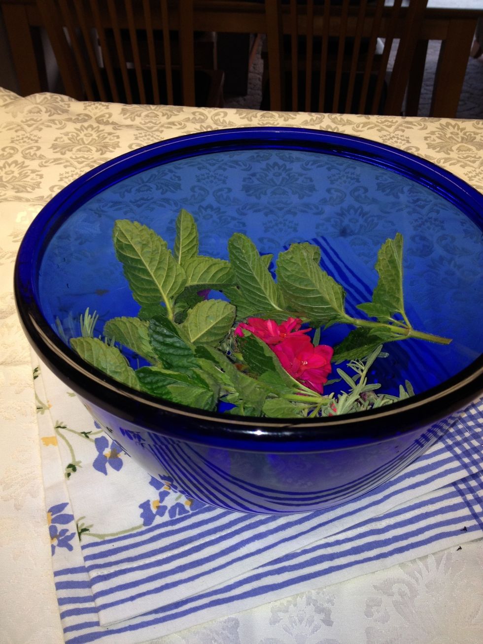 Line the bottom of a large bowl with a layer of flowers.