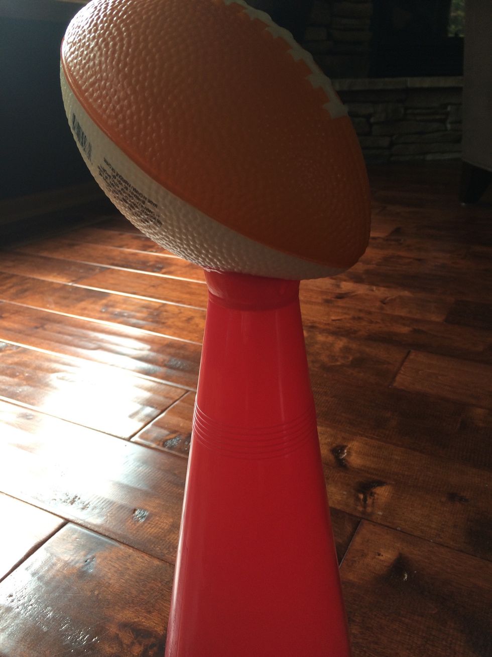 Line the opening of the mega phone with a bead of the glue and place the football on top, hold for at least 30 seconds. Let dry for 24 hours.