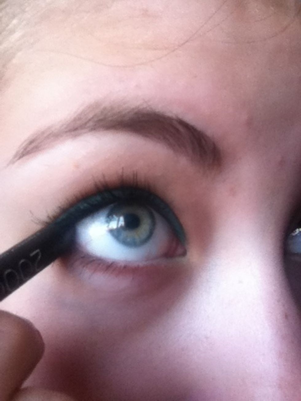Line the outer corners of your lower lashlines with the same black kohl pencil.