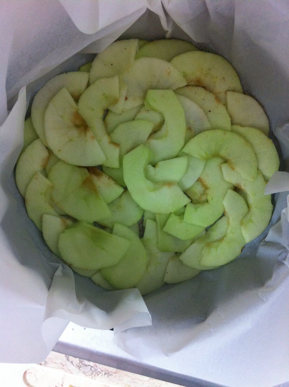 Line the pan with the sliced apples