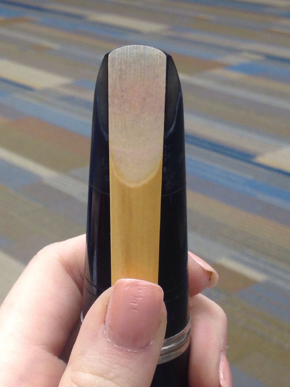 Line the reed up with along the flat part of the mouth piece.