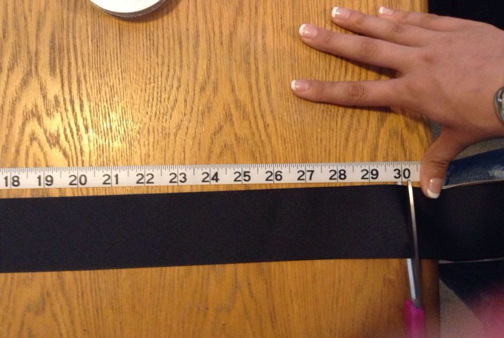 Line the ribbon up as evenly as possible with the measuring tape for accuracy and cut.