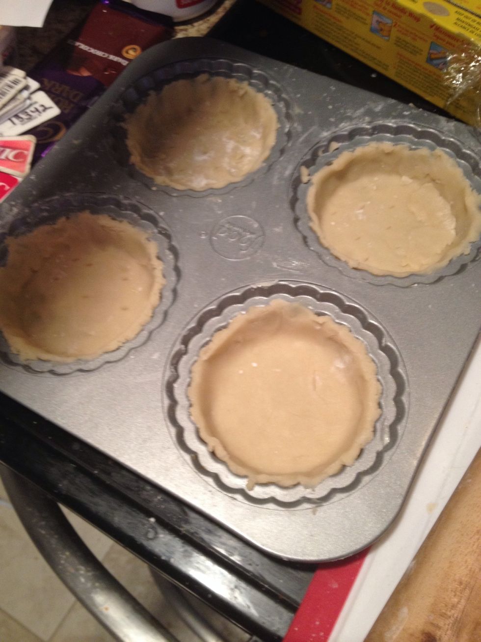 Line the tins with the pastry and trim around the edges to make the tartlets