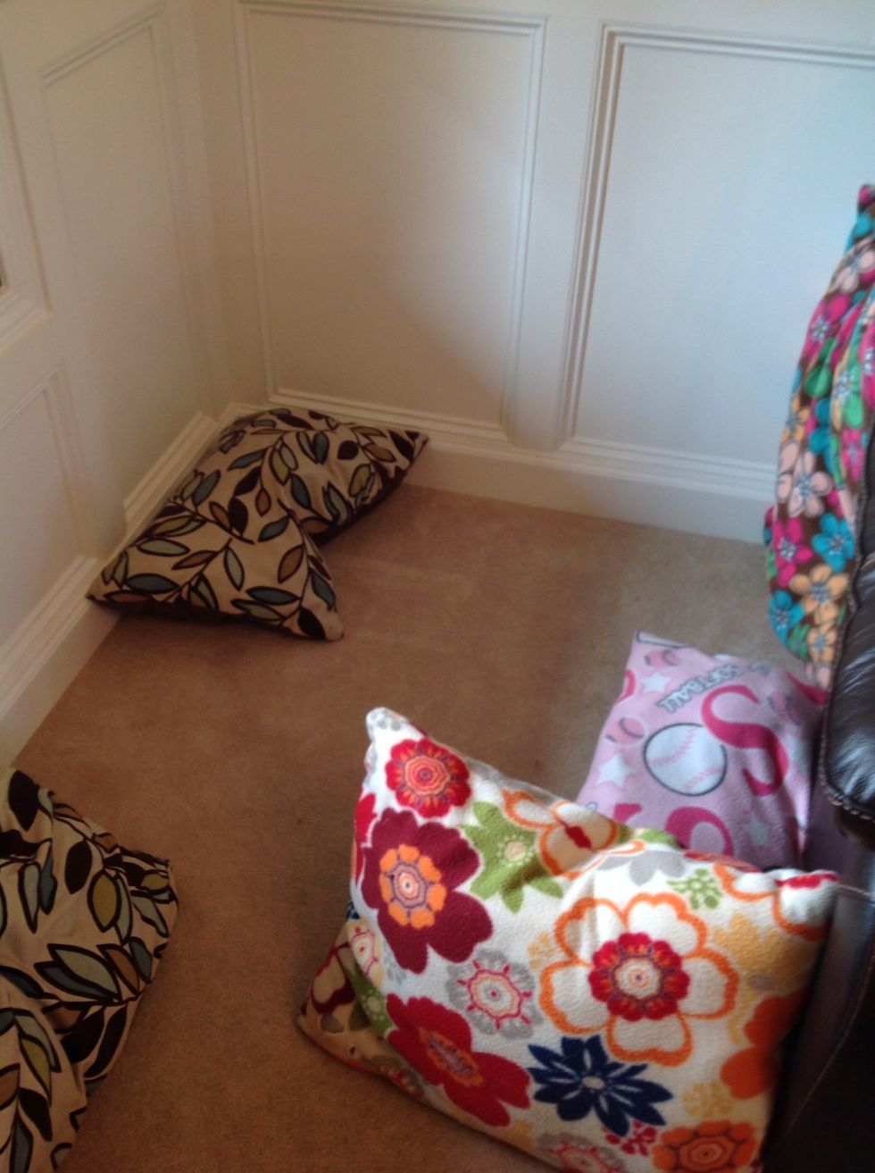 Line the walls with any kind of pillows. Make sure to cover up any holes or creases.