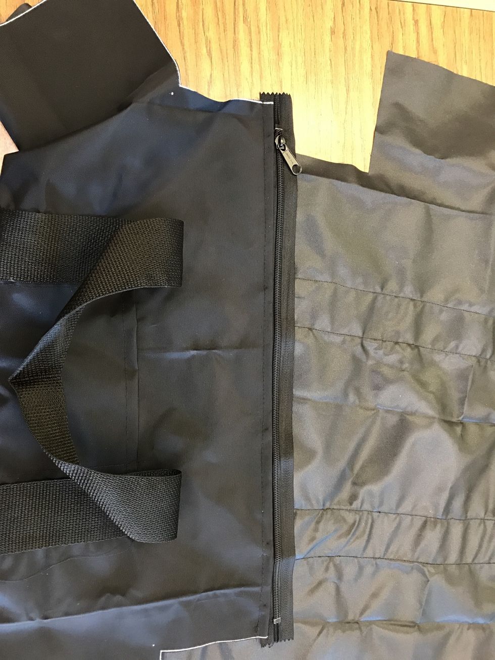 Line the zipper up to one of the sides you just stitched (M-N or O-P) and pin. Be sure you have an equal amount of extra on each side.