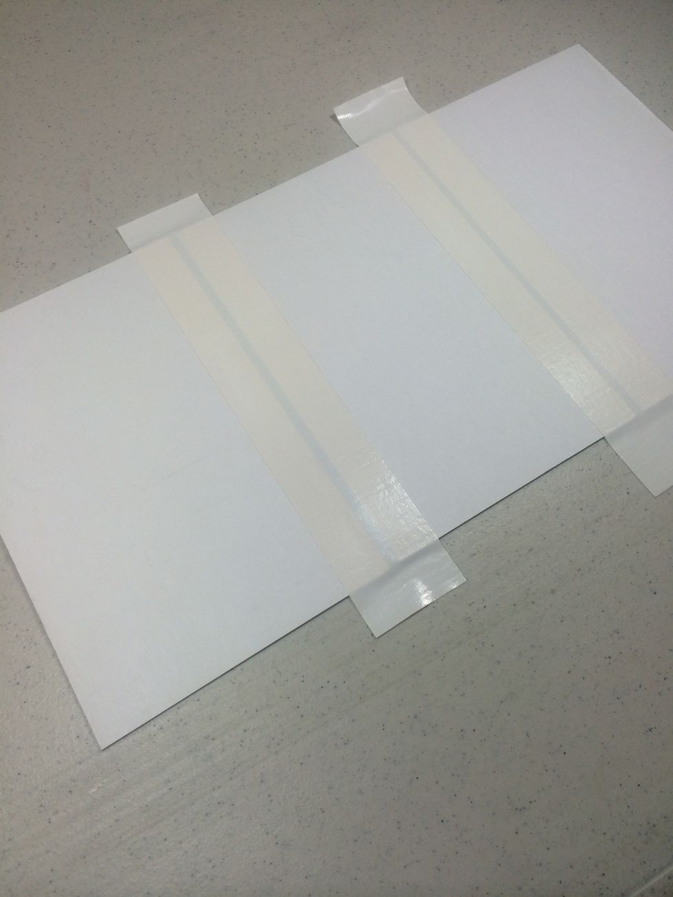 Line them up leaving 1/2" of space between. The smallest one is on the far right. Add white duct tape across seams. This is the interior of the folio.