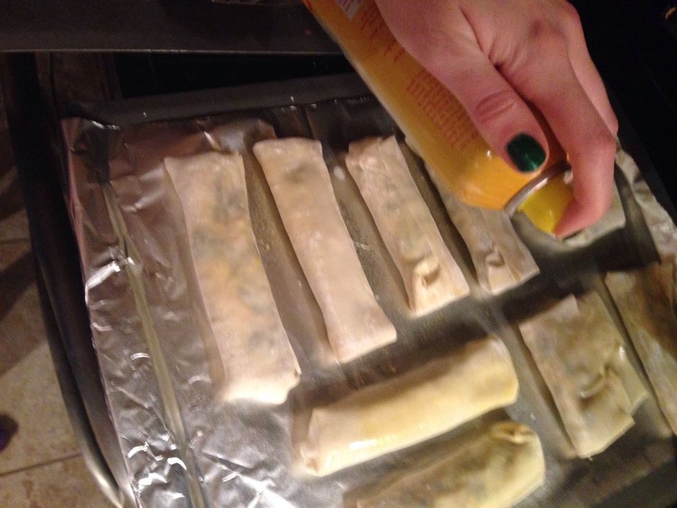 Line them up on the cookie sheets and lightly spray them with cooking spray.