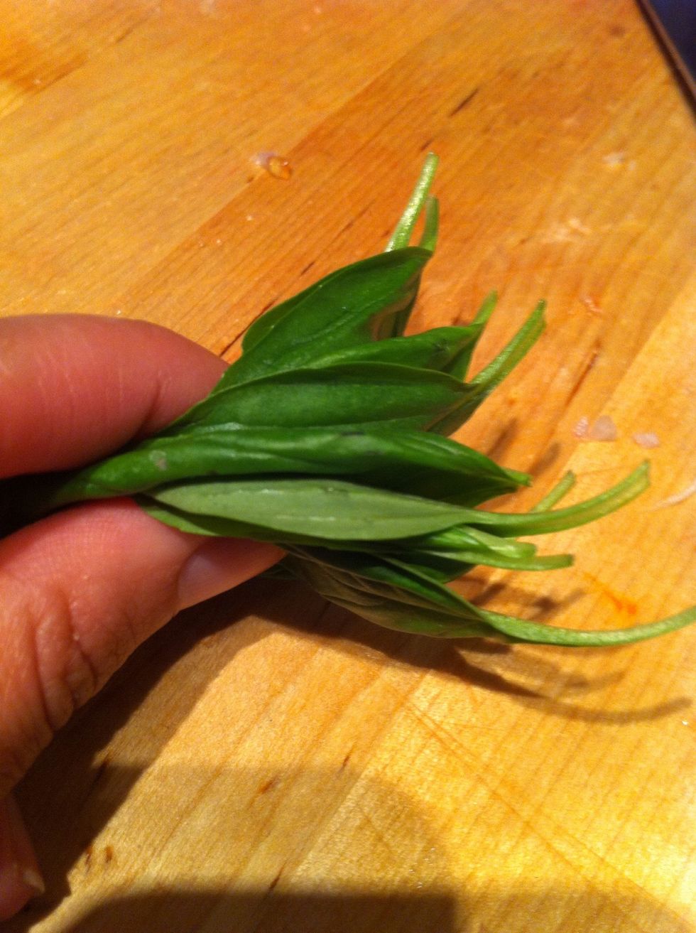 Line up basil leaves, thinly slice from stem to tip.