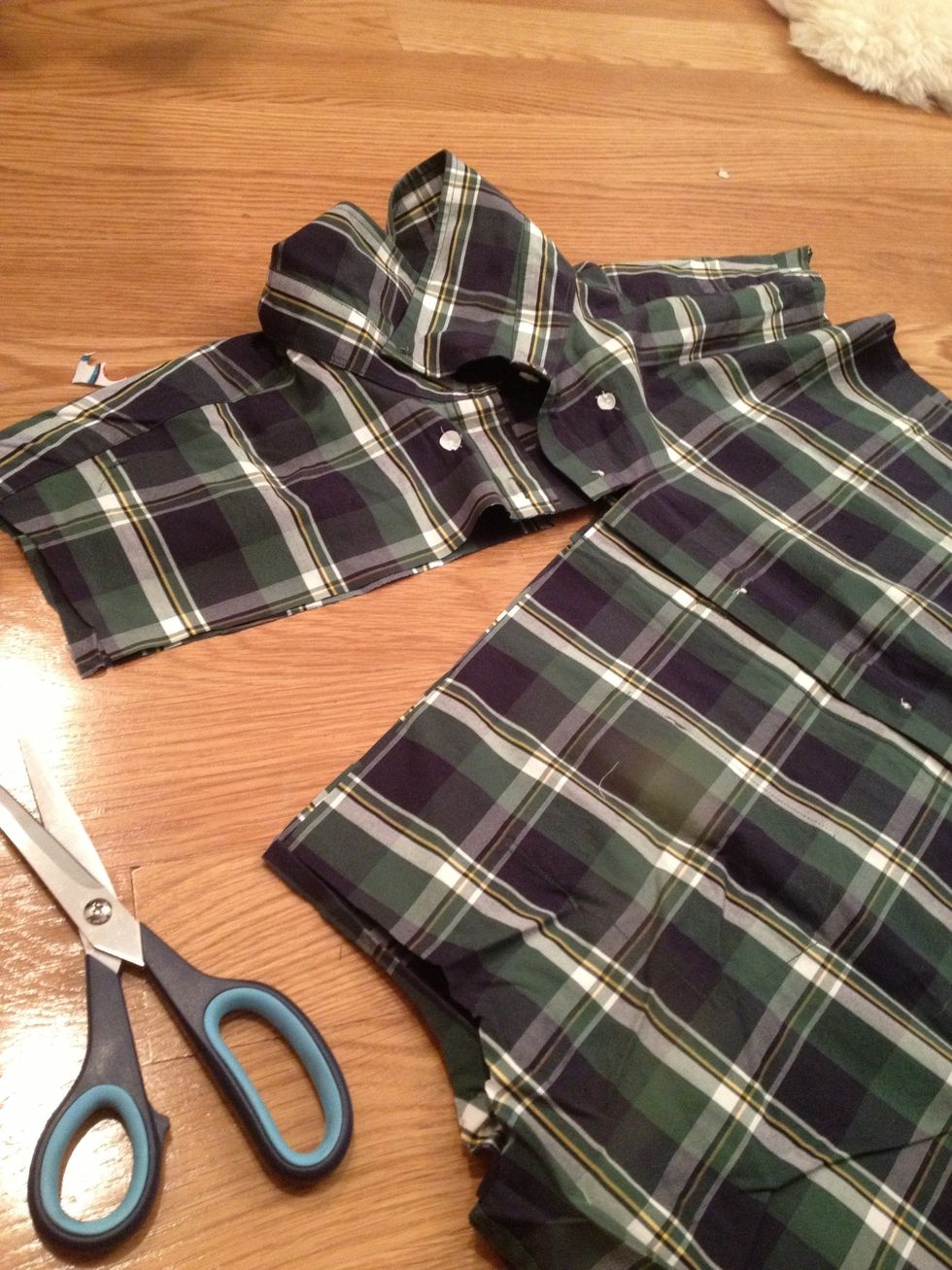 Line up the buttons. Cut all the way through, underneath the collar. You will now have 4 pieces (2 sleeves, collar, and torso).