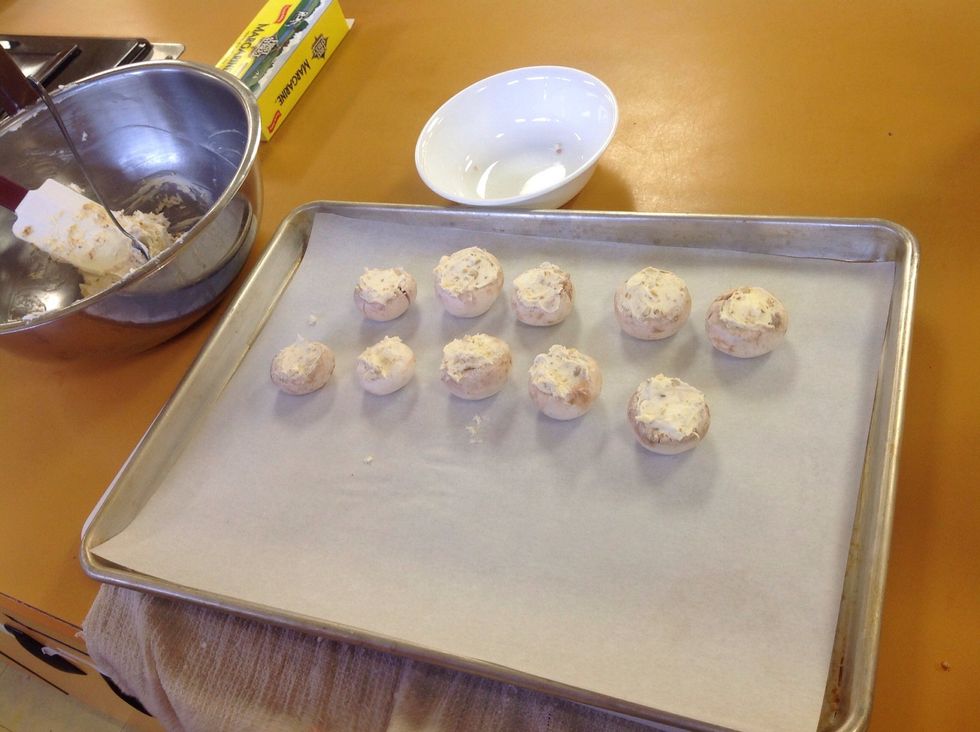 Line up the filled mushrooms on the sheet tray, make sure they are all standing up straight.