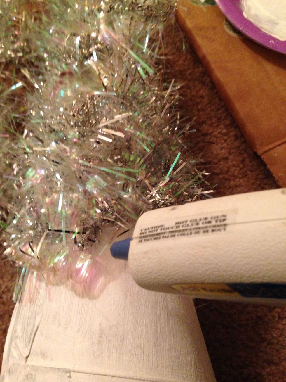 Line up the next piece of garland with the first and glue down an end piece.