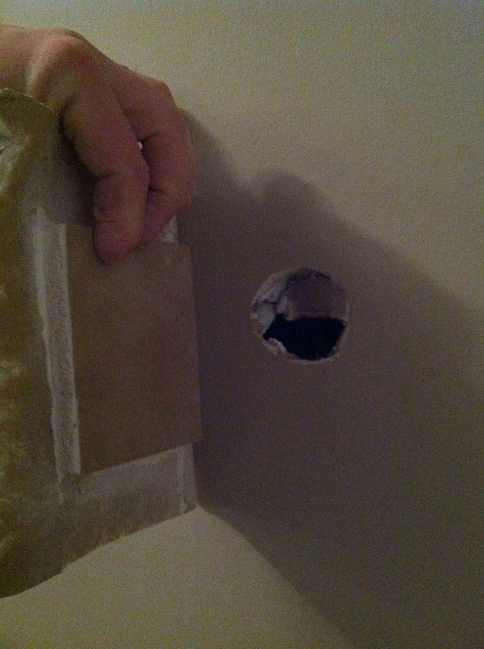 Line up the repair piece to cover the hole and any damage portion of the wall.