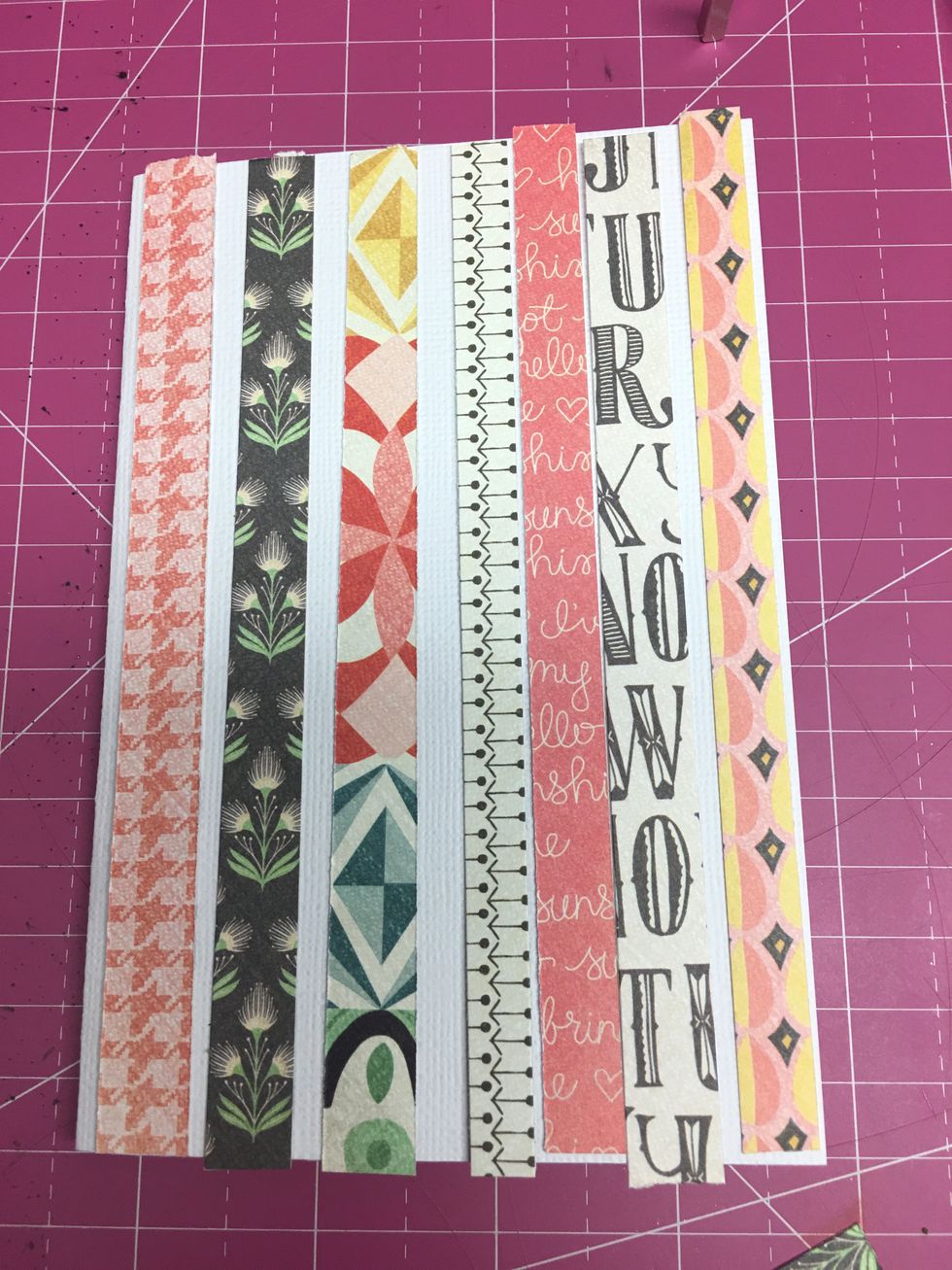 Line up the strips of paper vertically along the face of the card in the pattern that you like.