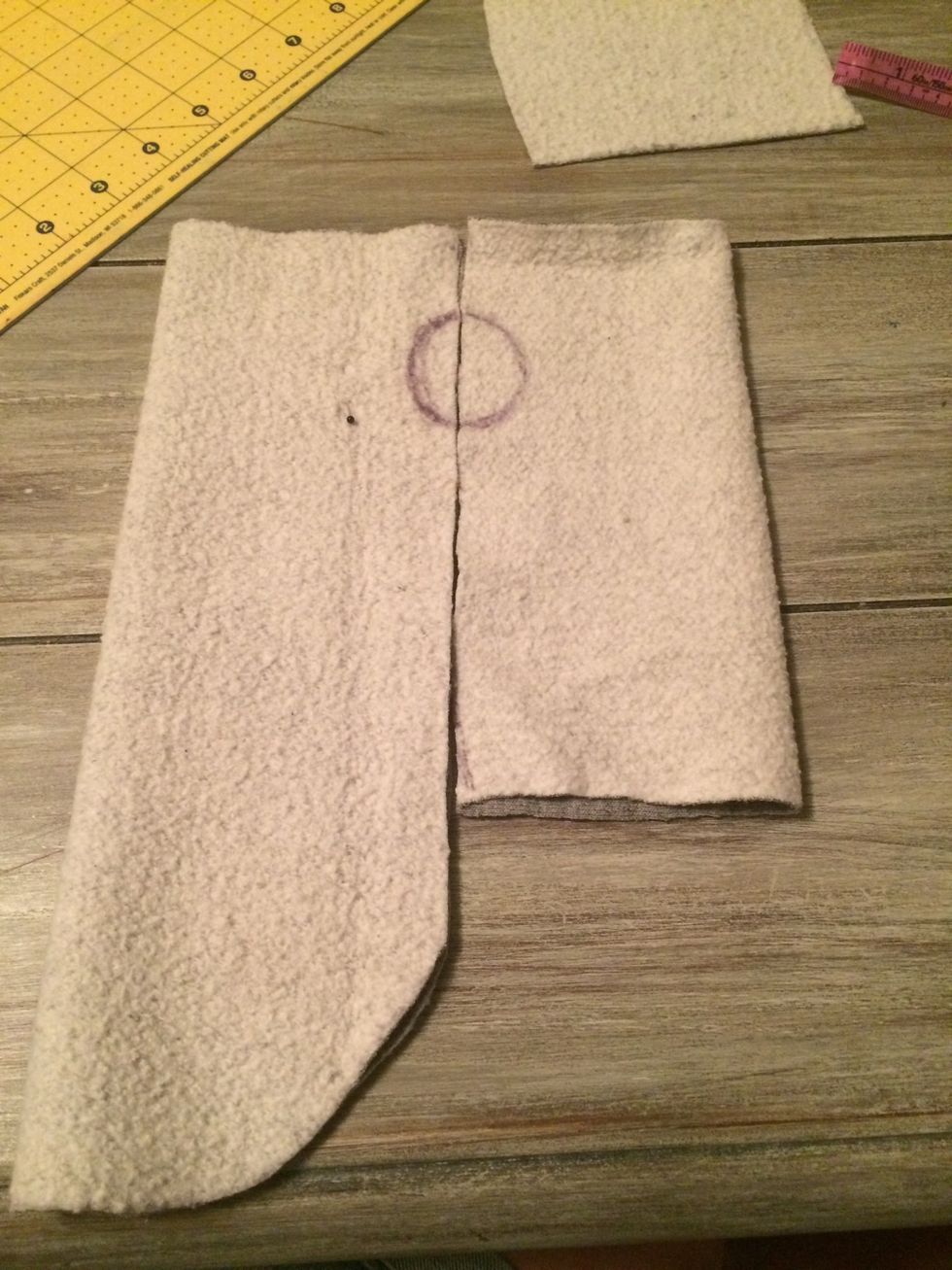 Line up the top and bottom pieces, folded length side and draw a circle between the two for the arm holes. These will get bigger later so done go too big here.