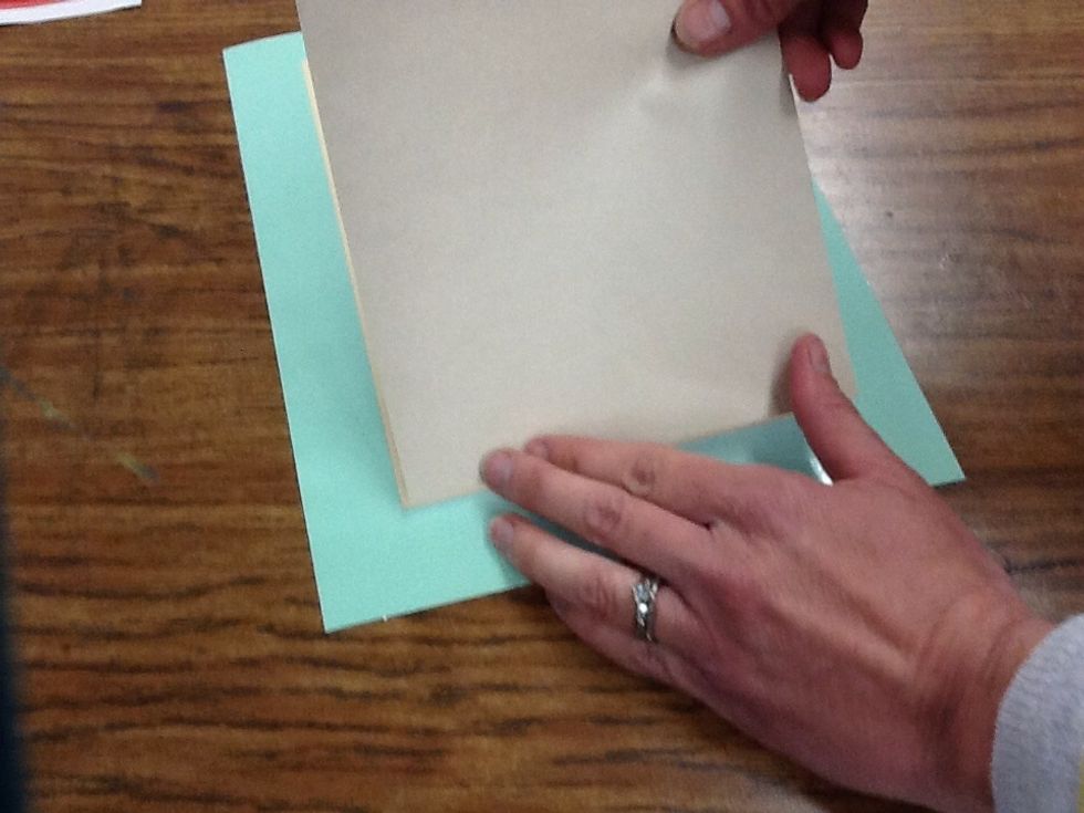 Line your paper up with the manilla area on the registration board.