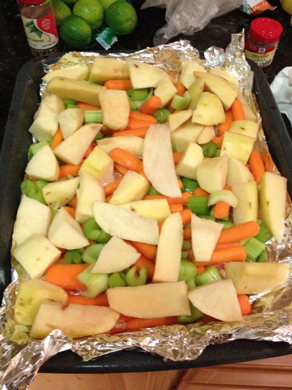 Line your roasting pan with chopped veggies and potatoes.