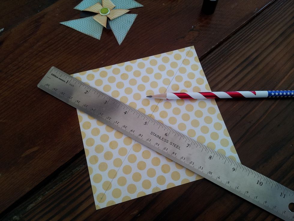 Line your ruler up on the diagonal end points of your paper and trace with a pencil. Then do the other side. You should have a big X when you are done.