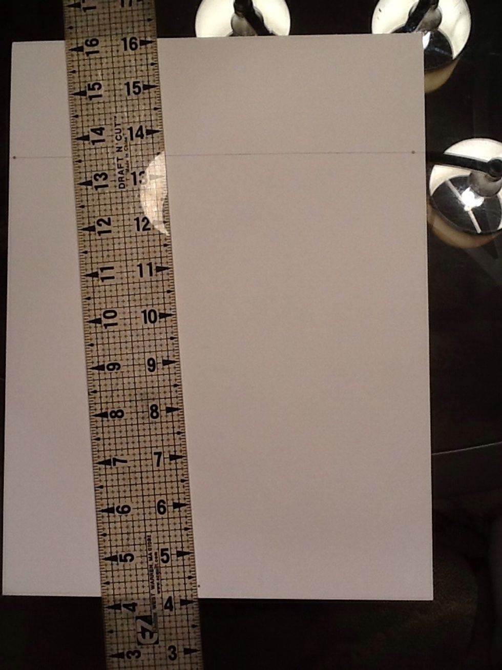 Line your ruler up with the 3rd vanishing point to draw the center line for your box.