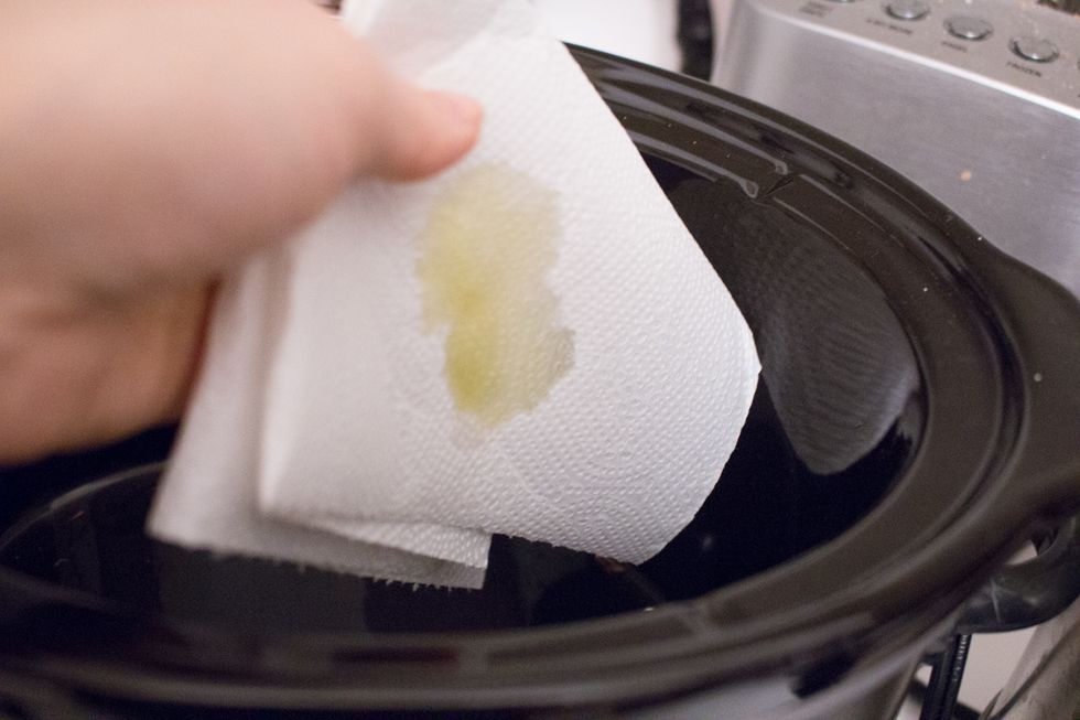 Line your slow cooker pot with cooking oil.