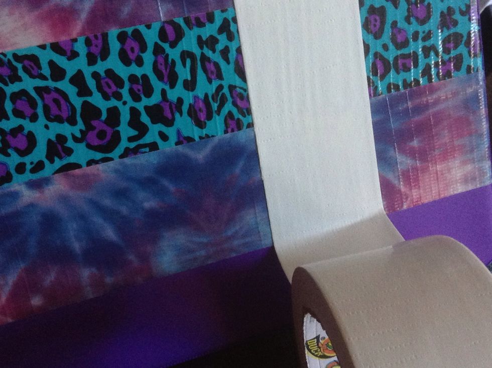 Line your tape up with the mark, and carefully start sticking it down. It should be parallel to the top edge.