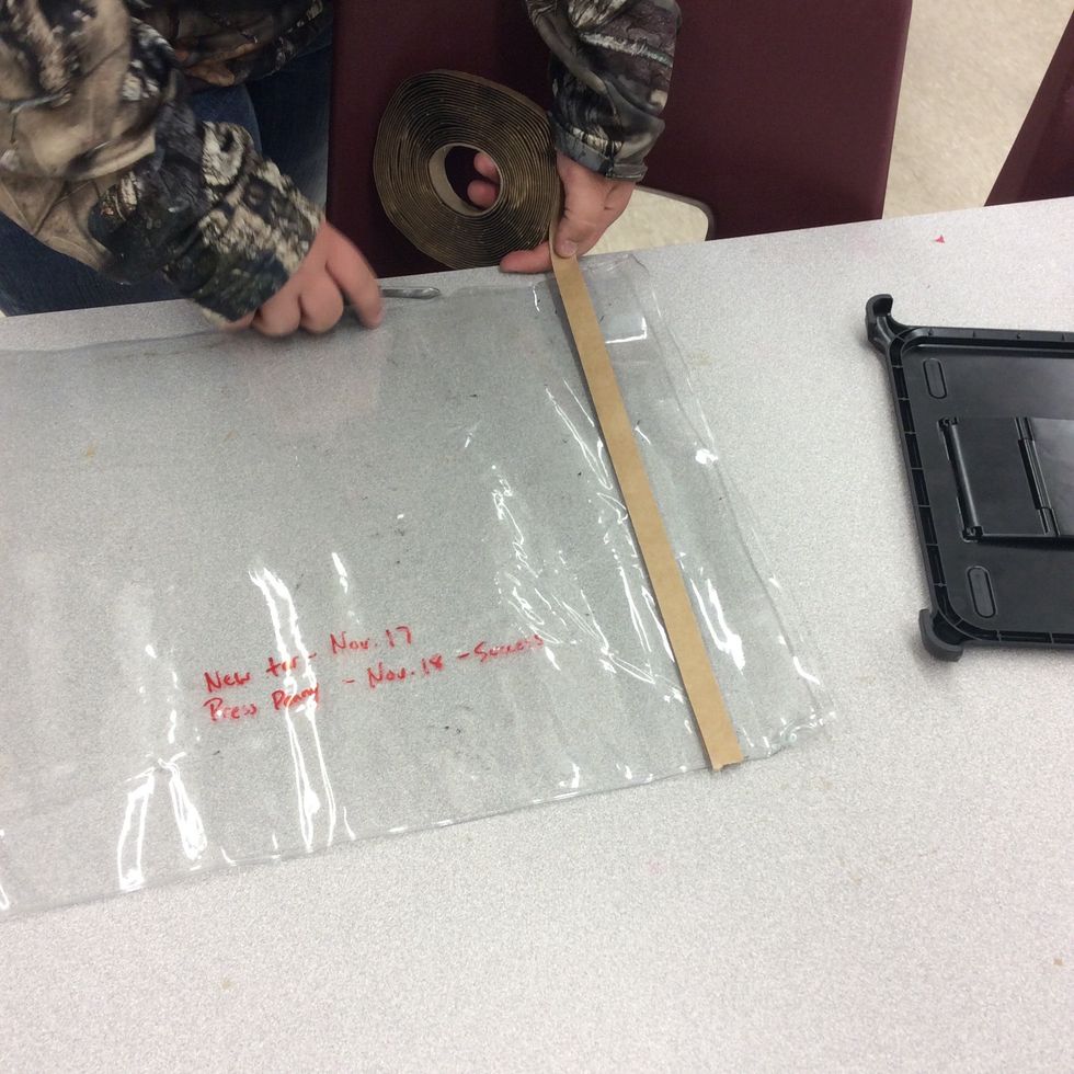 Lining the tar up to put it inside the bag.