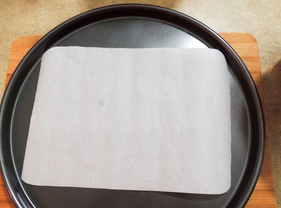 Lining up parchment paper on baking tray/sheet