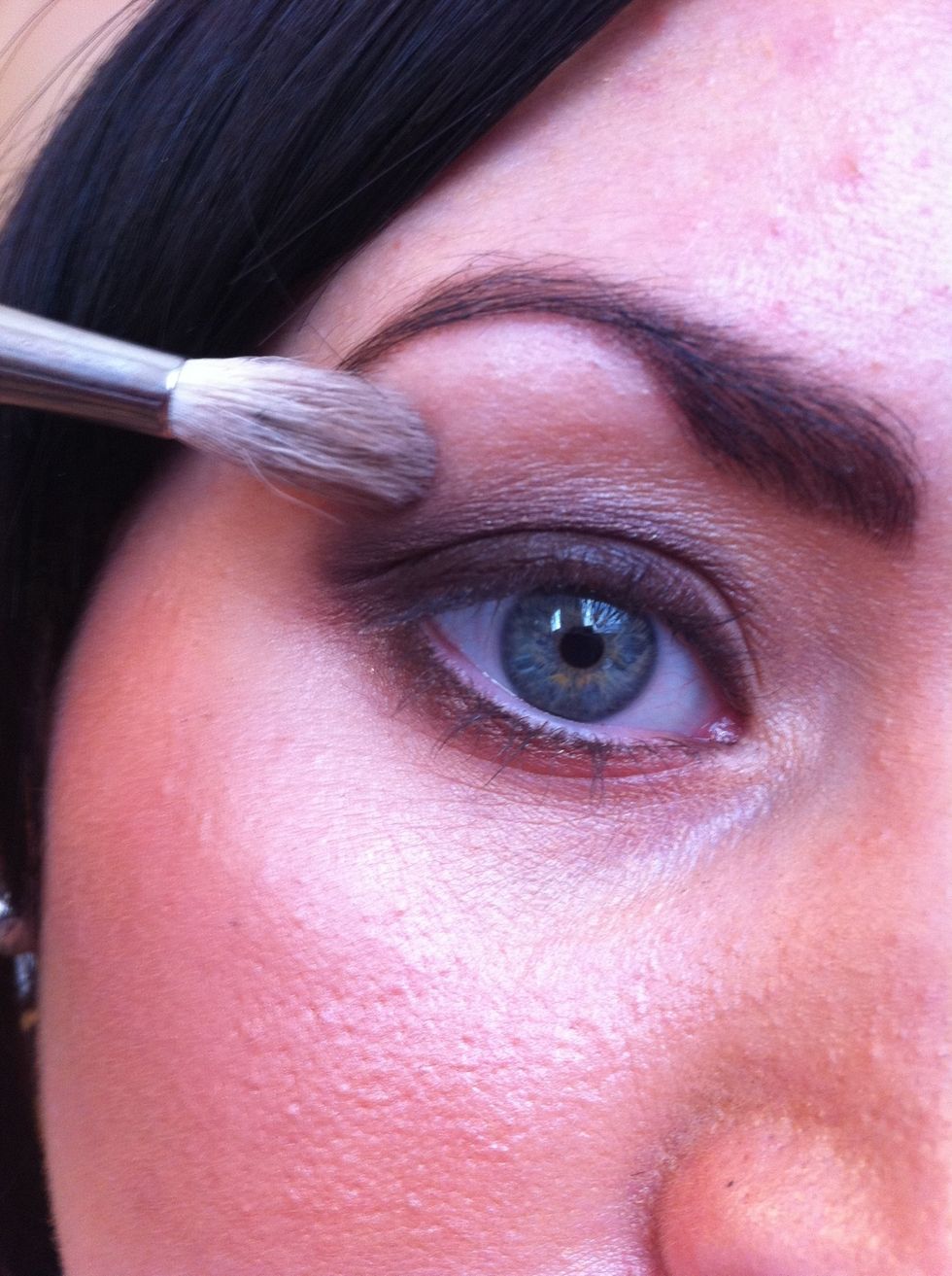 Load a fluffy blending brush with a warm black brown eyeshadow and blending the shade into the crease area to set the eyeliner.The more blended the more smokier the look is!