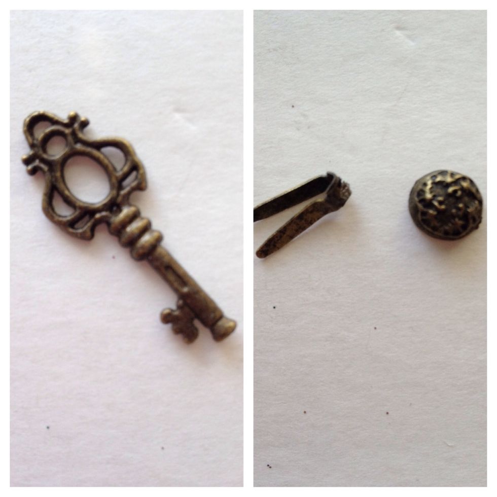 Locate a small key and a stamped brad. Break the legs off the brad.