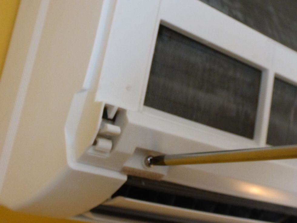 Locate and remove the chassis screws. On this particular model, there are 4 screws which become visible once the front cover is removed. You may have to search for screw covers.