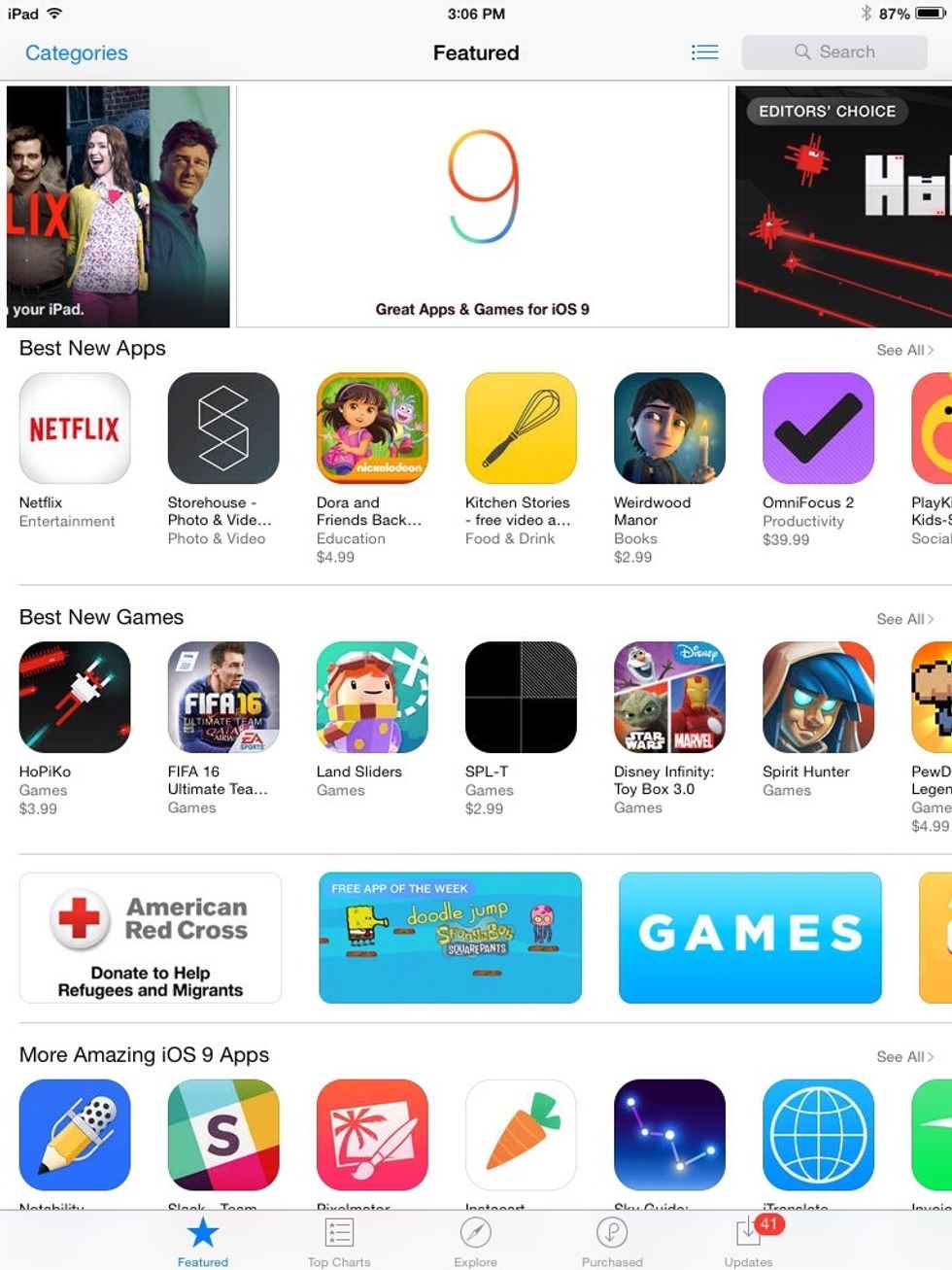 Locate "Purchased" along the bottom of the screen and tap it. It is between "Explore" and "Updates" in line with "Featured."