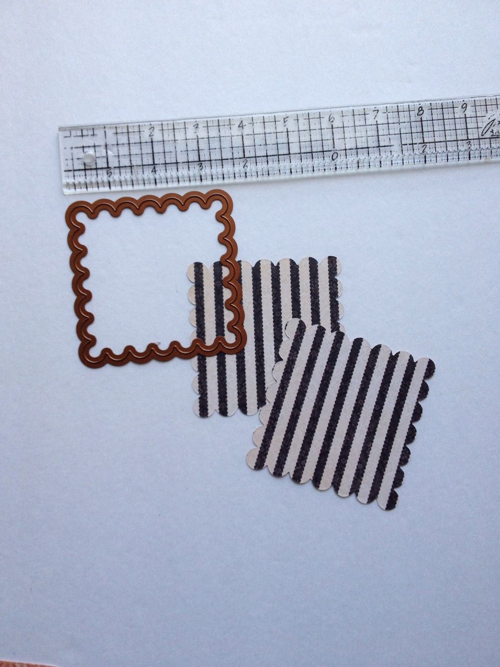 Locate the "Accessorize" paper from your 8x8 pad and cut (2) 4" square pieces. Use your die cutting machine and the 3.5" Spellbinders Scalloped square die to cut your papers.