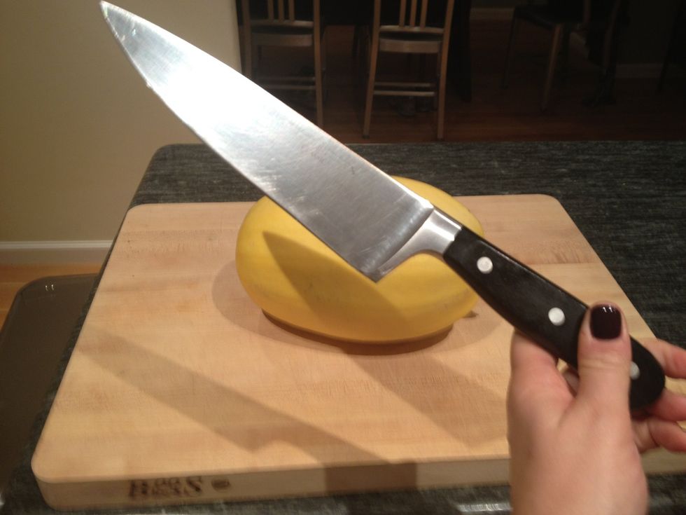 Locate the biggest, sharpest knife you have! Slice the squash in half, lengthwise.