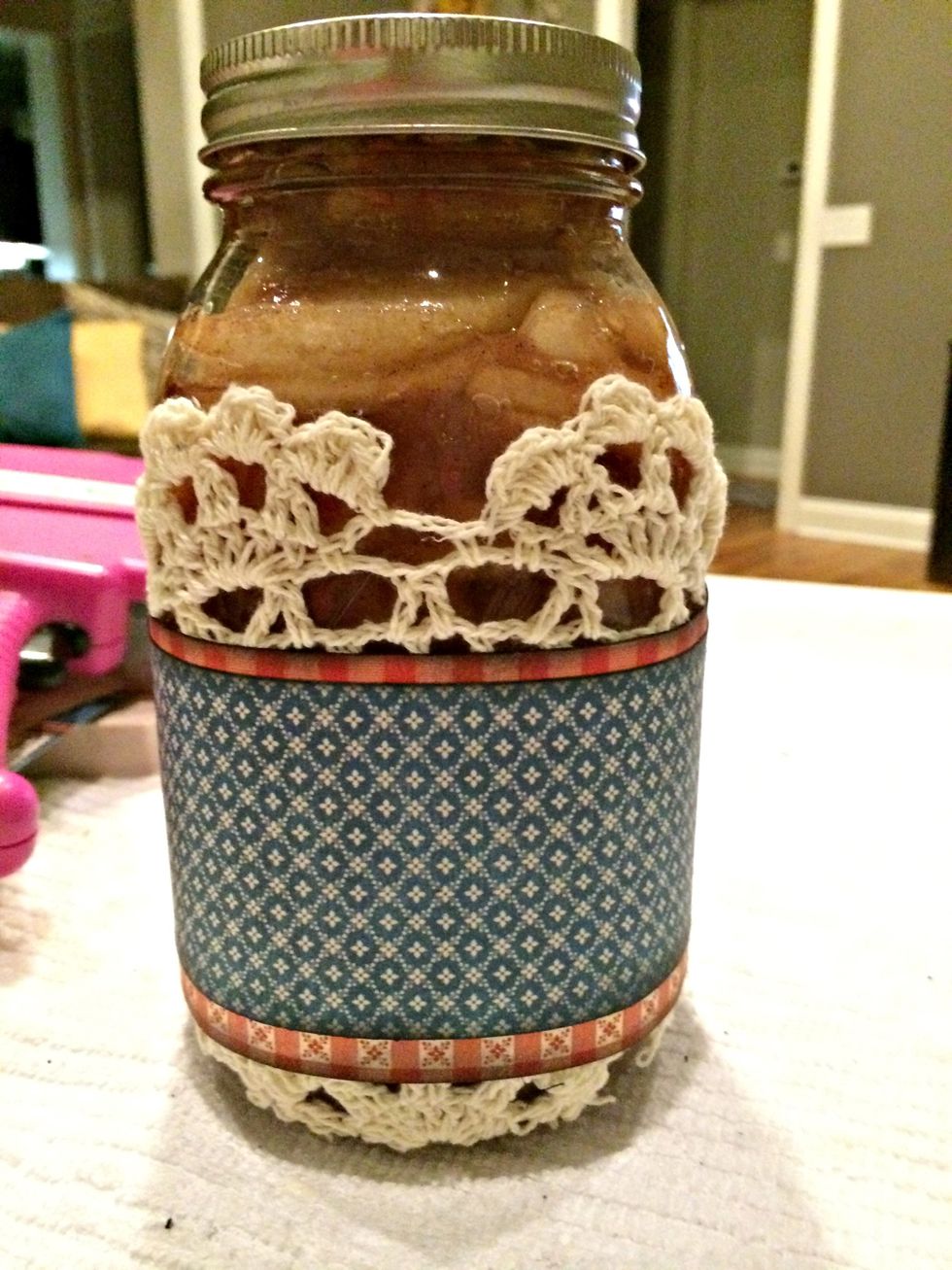 Locate the center of the the cardstock created by gluing the small piece on top of the large one (the 6" mark). and center it with the front of the jar. Apply glue and adhere.