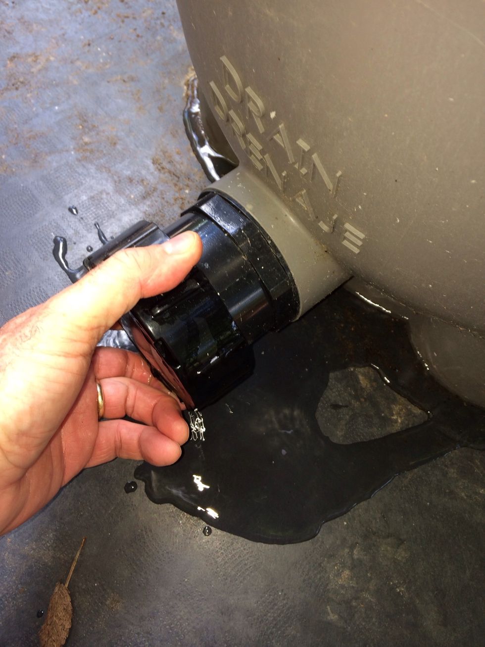 Locate the drain at the bottom of the filter and open it. Naturally water is going to rush out