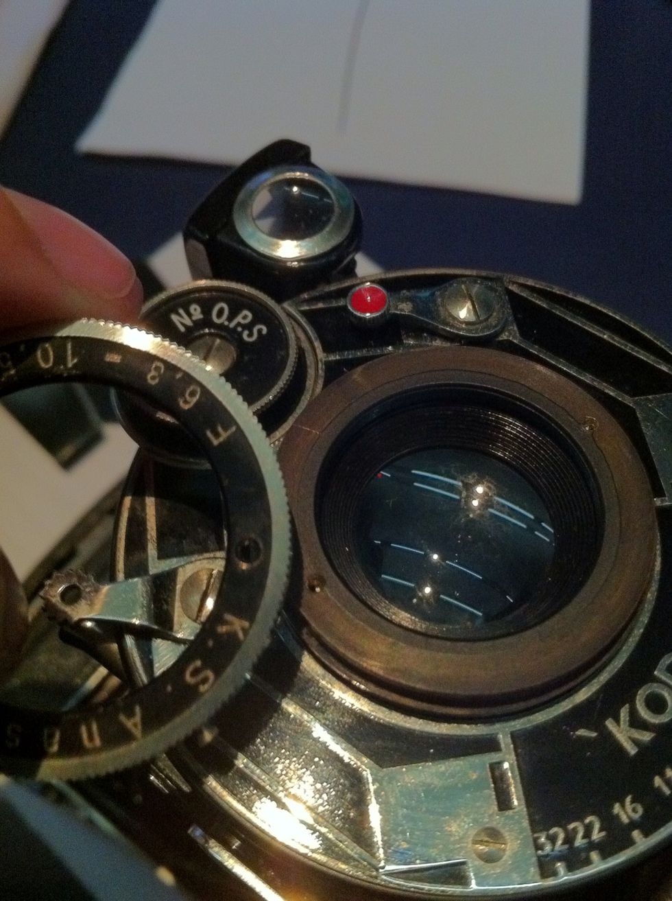 Locate the holes and line up using the infinite mark as our reference . We want the inf notch to line up with the red marker. If it doesn't the untwist the lens until it does