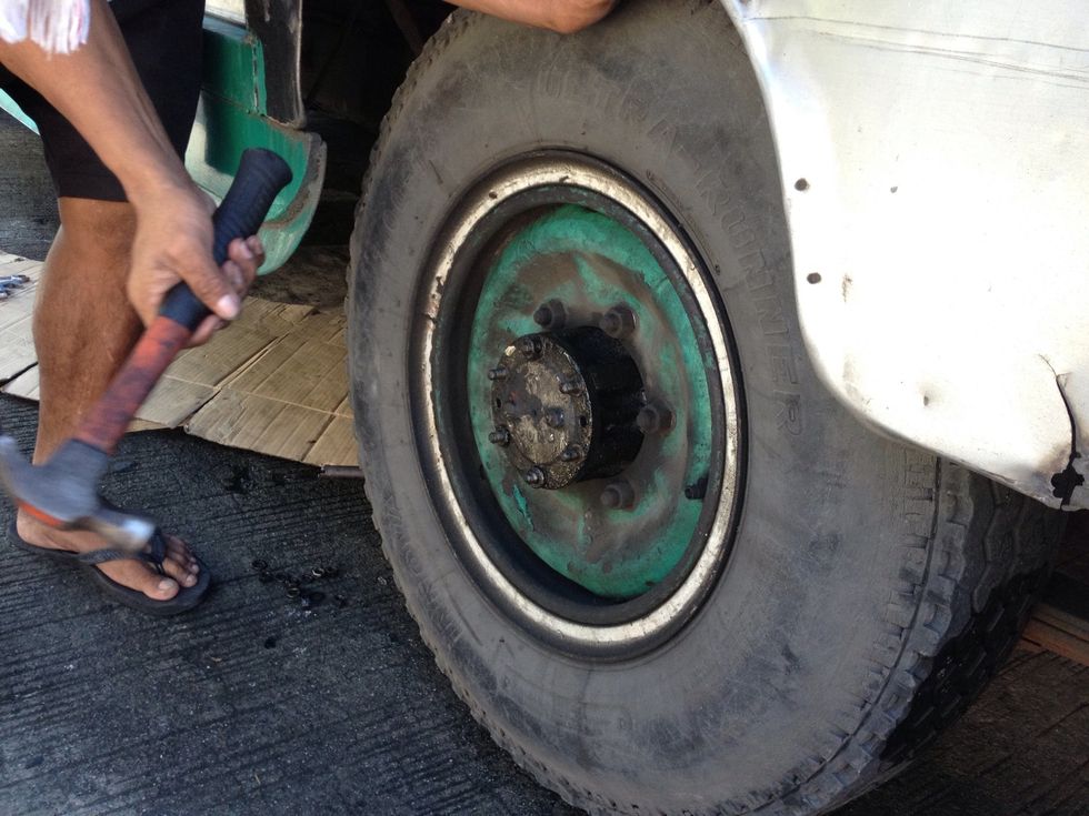 Locate the tire with oil leak problem. You should see some oil leaks from the center.